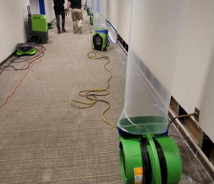 SERVPRO equipment set up in a water damaged hallway